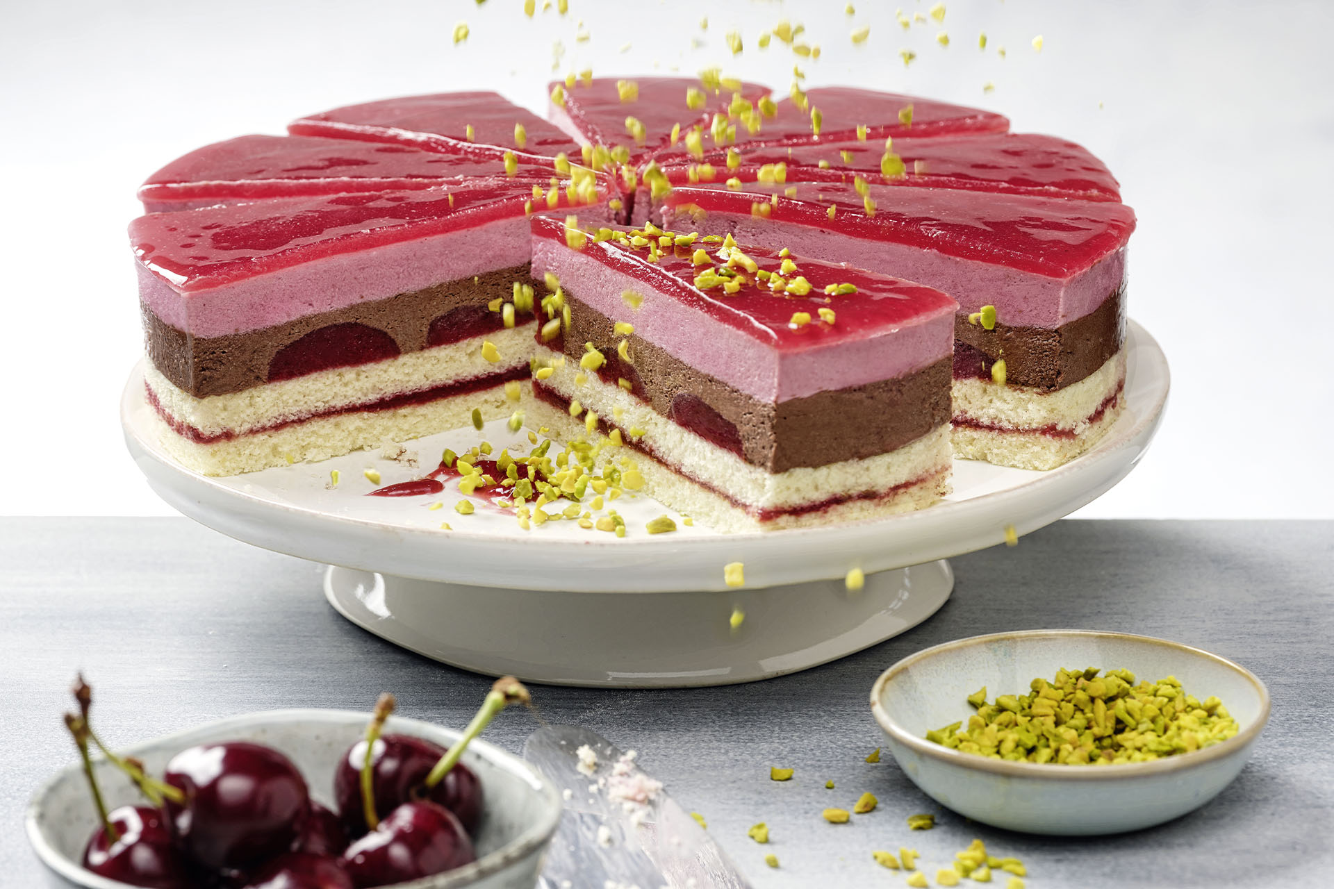 Cherry cream cake with a slice cut out